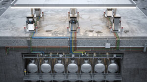Vue technique d’une station-service moderne montrant les cuves souterraines, les pompes et les îlots de distribution, dans un aménagement industriel détaillé.